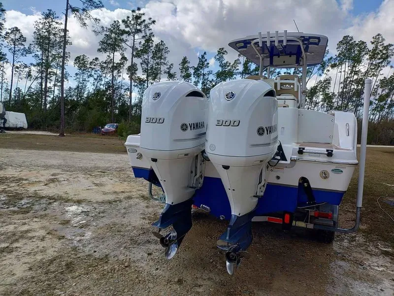 Slide: The Image of 2019 NauticStar 28 XS Offshore boat with twin Yamaha 300 engines, parked outdoors. - 15
