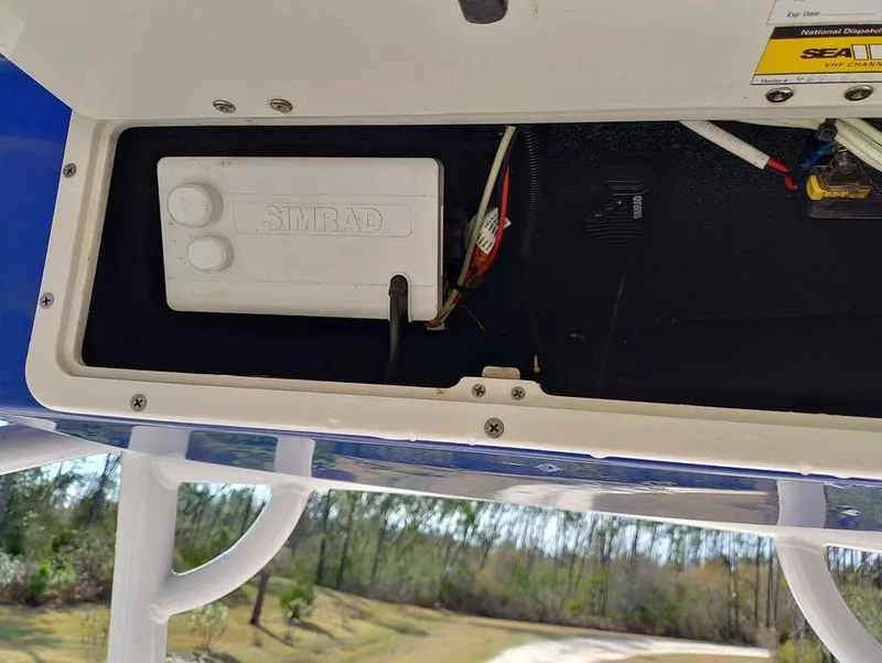 Slide: The Image of 2019 NauticStar 28 XS Offshore boat with Simrad electronics compartment. - 31