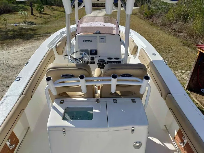 Slide: The Image of 2019 NauticStar 28 XS Offshore boat interior with helm and seating. - 32