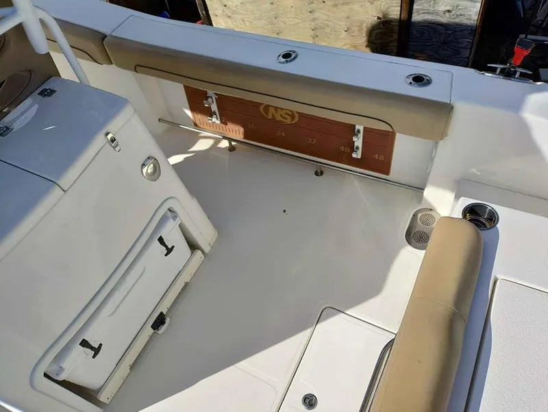 Slide: The Image of 2019 NauticStar 28 XS Offshore boat interior with seating and storage compartments. - 35