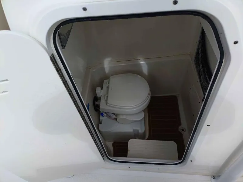 Slide: The Image of 2019 NauticStar 28 XS Offshore boat interior with compact marine toilet. - 38