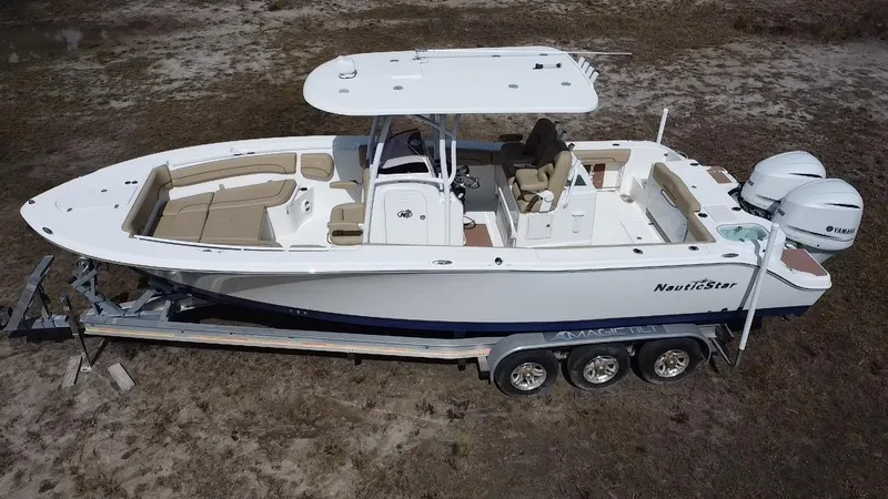 Slide: The Image of 2019 NauticStar 28 XS Offshore boat on trailer, side view, outdoors. - 4