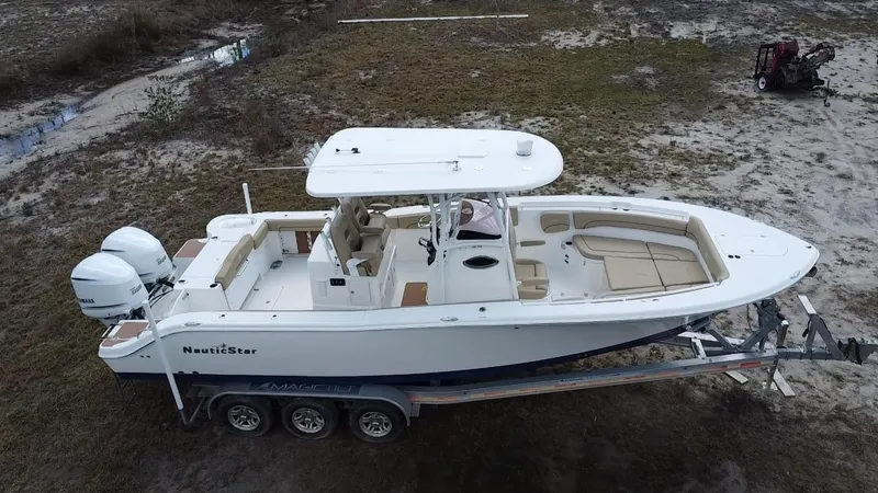 Slide: The Image of 2019 NauticStar 28 XS Offshore boat on trailer, side view. - 8