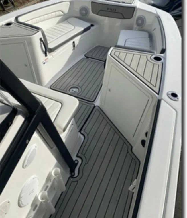 Slide: The Image of 2021 Yamaha Boats 210 FSH Sport interior with seating and storage compartments. - 11