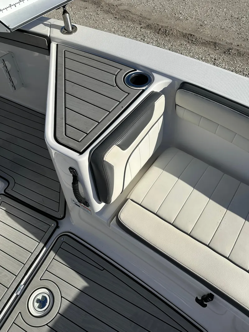 Slide: The Image of 2021 Yamaha Boats 210 FSH Sport interior seating with cup holder and storage. - 13
