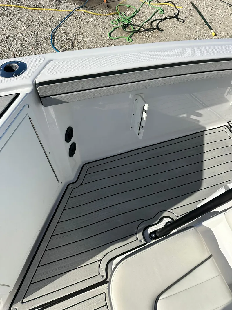 Slide: The Image of 2021 Yamaha Boats 210 FSH Sport interior, featuring sleek deck design and modern fittings. - 18