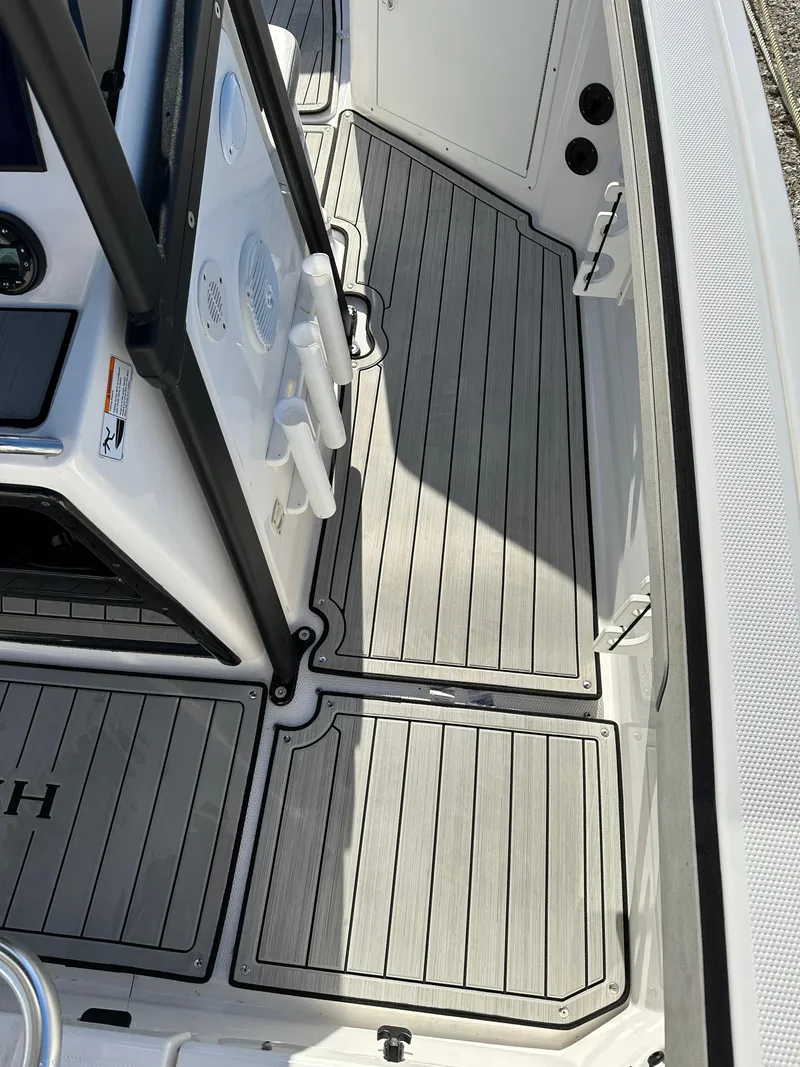 Slide: The Image of 2021 Yamaha Boats 210 FSH Sport deck with sleek, modern design and durable flooring. - 20