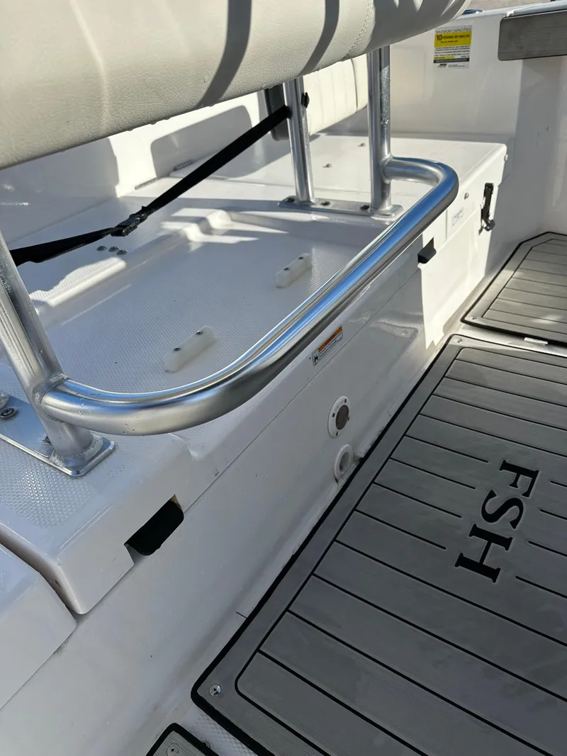 Slide: The Image of 2021 Yamaha Boats 210 FSH Sport interior, featuring seating and deck details. - 21
