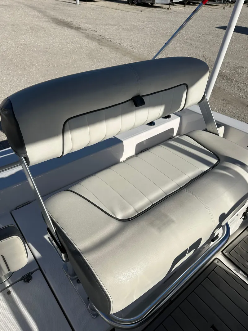 Slide: The Image of 2021 Yamaha Boats 210 FSH Sport seat, featuring sleek gray upholstery. - 22