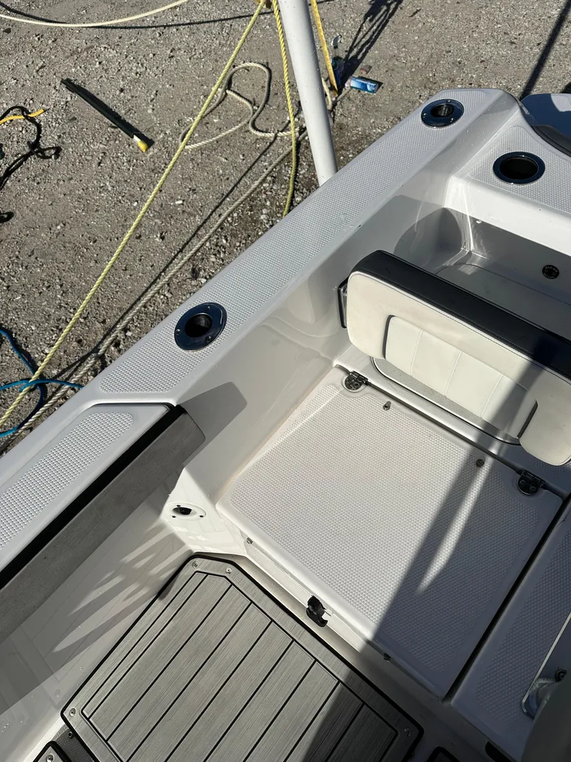 Slide: The Image of 2021 Yamaha Boats 210 FSH Sport interior with seating and deck details. - 23