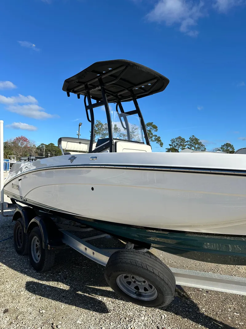 Slide: The Image of 2021 Yamaha Boats 210 FSH Sport on trailer under clear blue sky. - 27