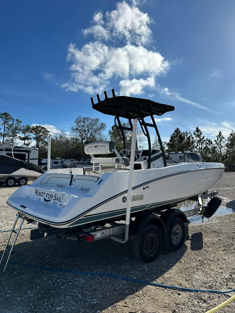 Slide: The Image of 2021 Yamaha Boats 210 FSH Sport on trailer under clear blue sky. - 28