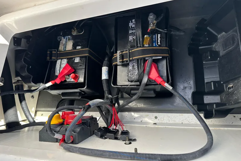 Slide: The Image of Battery compartment of 2021 Yamaha Boats 210 FSH Sport with wiring connections. - 30