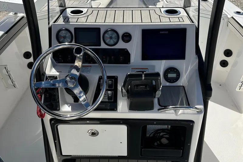 Slide: The Image of 2021 Yamaha Boats 210 FSH Sport dashboard with steering wheel and controls. - 35