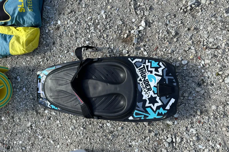 Slide: The Image of Thunder kneeboard on gravel, featuring bold graphics and foot strap. - 43