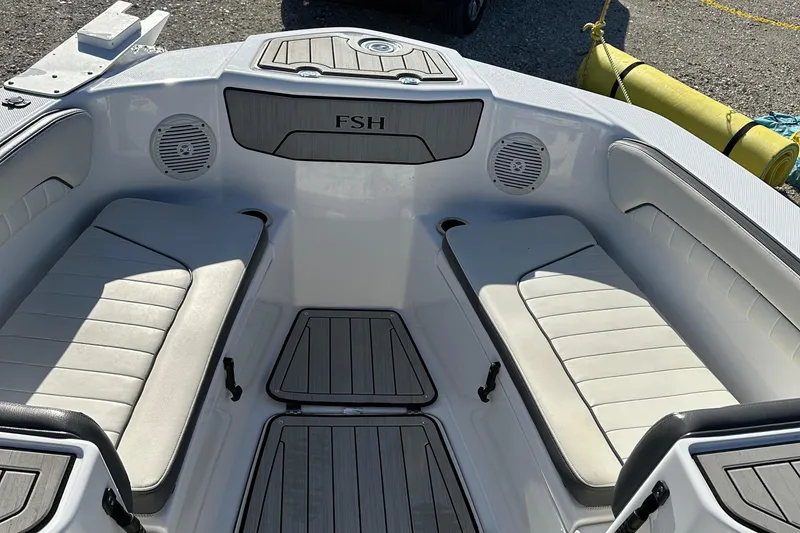 Slide: The Image of 2021 Yamaha Boats 210 FSH Sport interior with cushioned seating and speakers. - 44