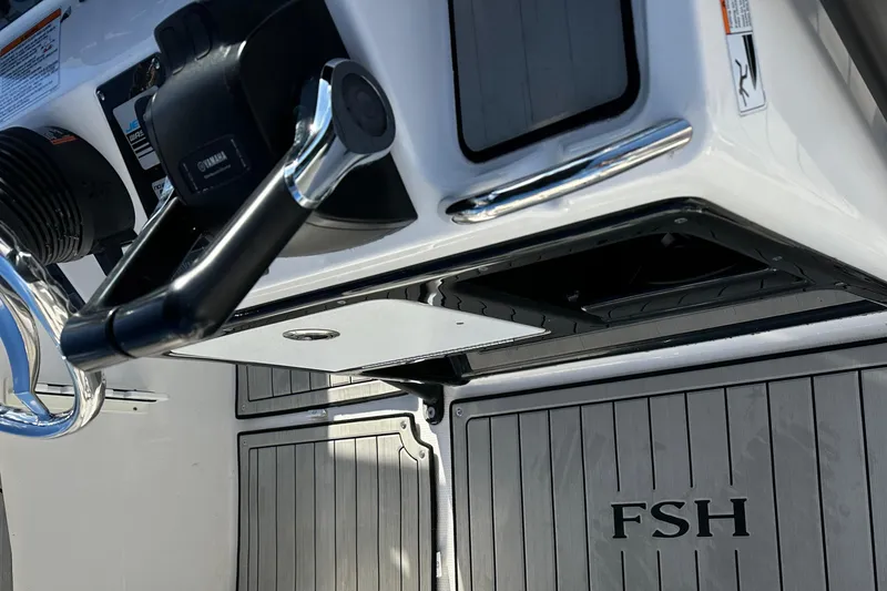 Slide: The Image of 2021 Yamaha Boats 210 FSH Sport interior with steering controls and FSH branding. - 46