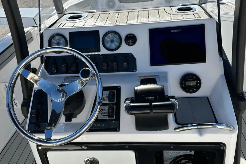 Slide: The Image of 2021 Yamaha Boats 210 FSH Sport dashboard with steering wheel and control panel. - 47