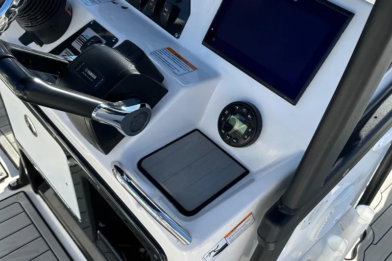 Slide: The Image of 2021 Yamaha Boats 210 FSH Sport dashboard with steering wheel and controls. - 49