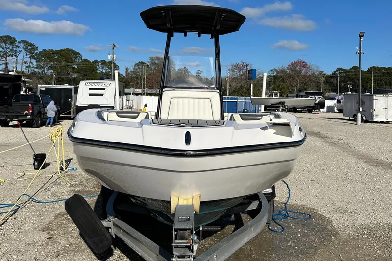 Slide: The Image of 2021 Yamaha Boats 210 FSH Sport on trailer, parked outdoors under clear sky. - 5