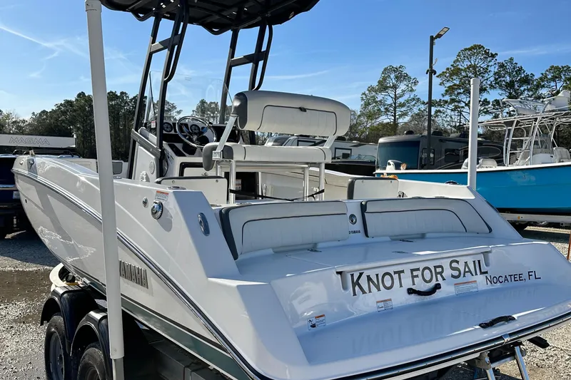 Slide: The Image of 2021 Yamaha Boats 210 FSH Sport on trailer, rear view, "Knot for Sail" text visible. - 6