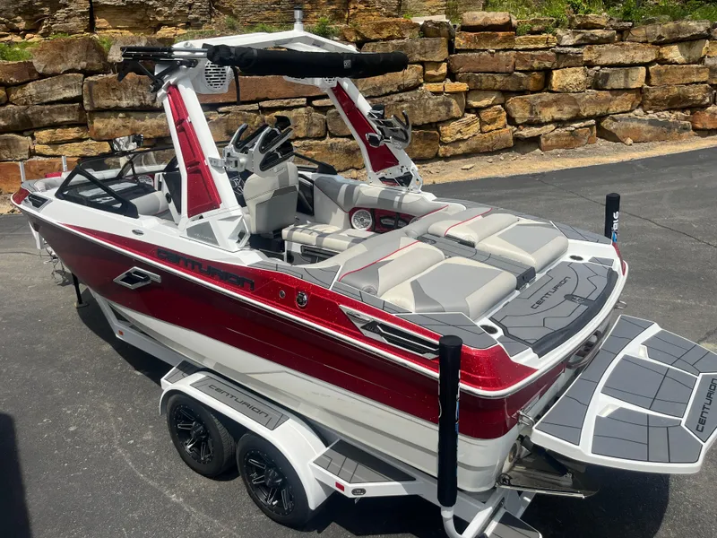 Slide: The Image of 2022 Centurion Ri230 boat with red and white design on a trailer. - 10