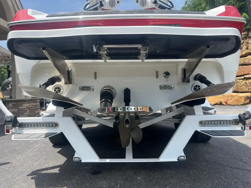 Slide: The Image of 2022 Centurion Ri230 boat rear view showing propeller and wakeboard features. - 11