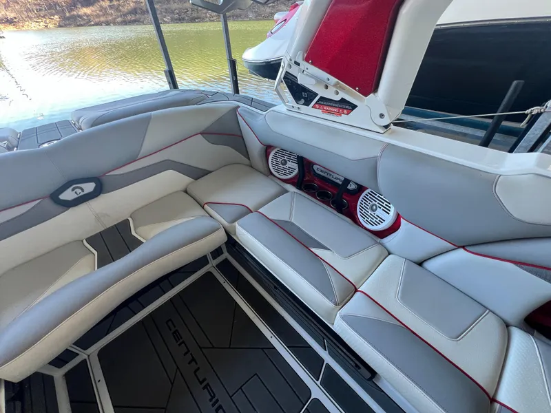 Slide: The Image of 2022 Centurion Ri230 boat interior with stylish seating and audio system. - 14