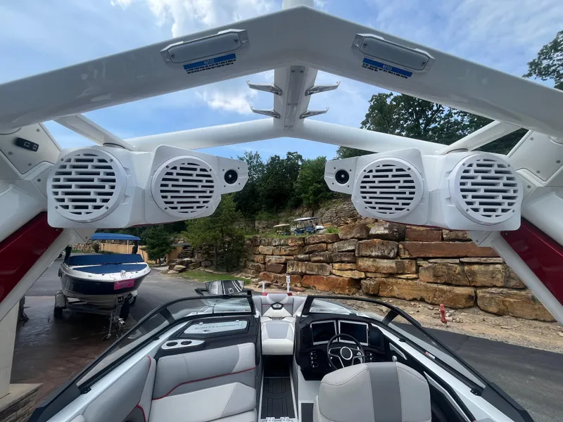 Slide: The Image of 2022 Centurion Ri230 boat interior with speakers and modern dashboard. - 17