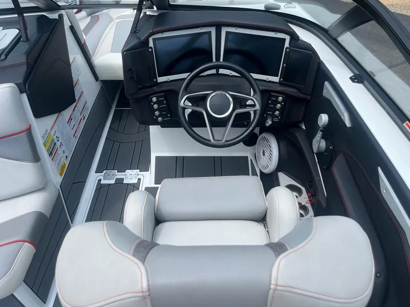 Slide: The Image of 2022 Centurion Ri230 boat cockpit with modern steering and dual screens. - 22