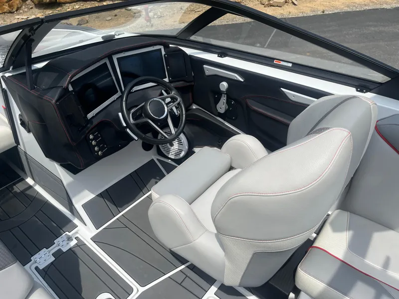 Slide: The Image of 2022 Centurion Ri230 boat interior with modern dashboard and steering wheel. - 25