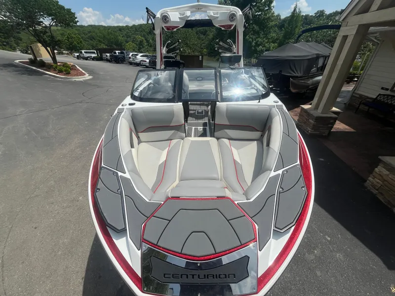 Slide: The Image of 2022 Centurion Ri230 boat with sleek design and spacious seating, parked outdoors. - 4