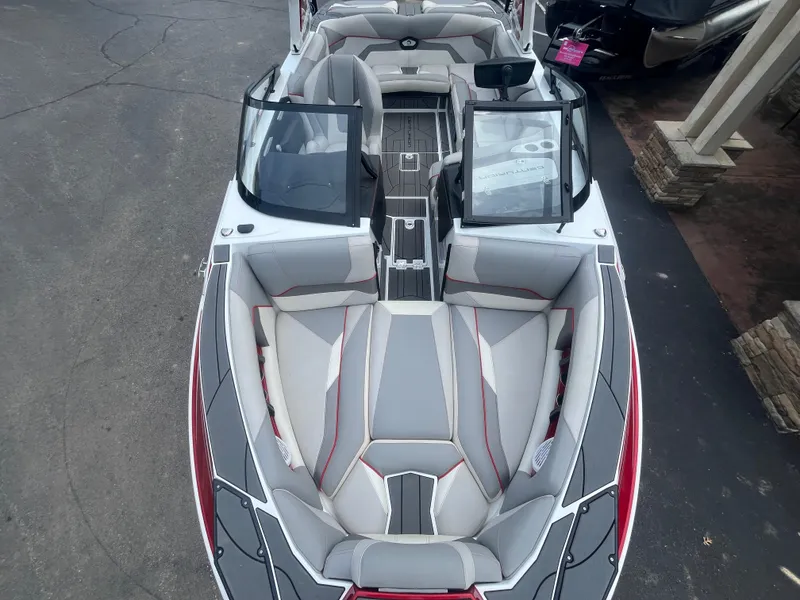 Slide: The Image of 2022 Centurion Ri230 boat interior with sleek gray and red seating design. - 5