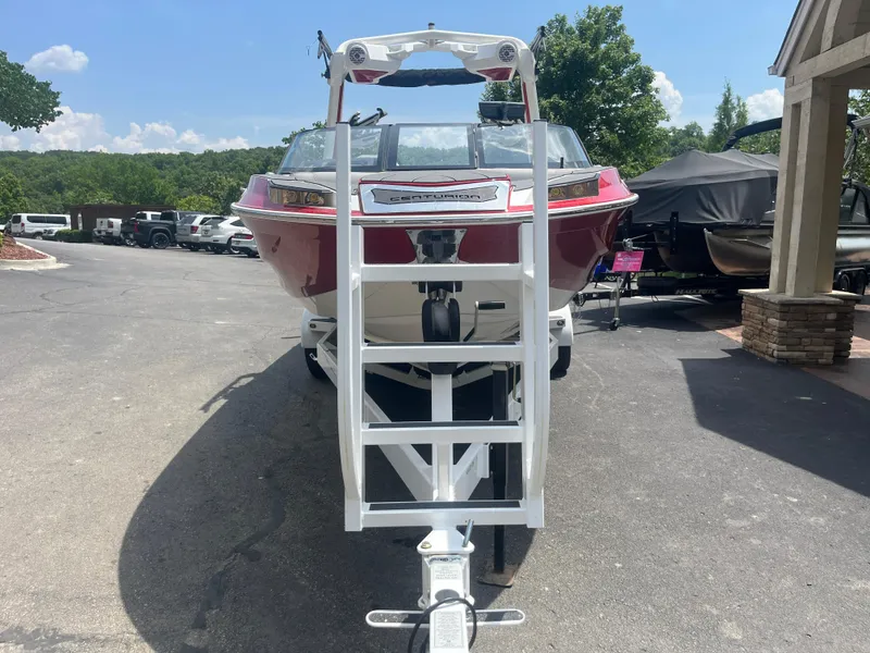 Slide: The Image of 2022 Centurion Ri230 boat on trailer, parked outdoors on a sunny day. - 7