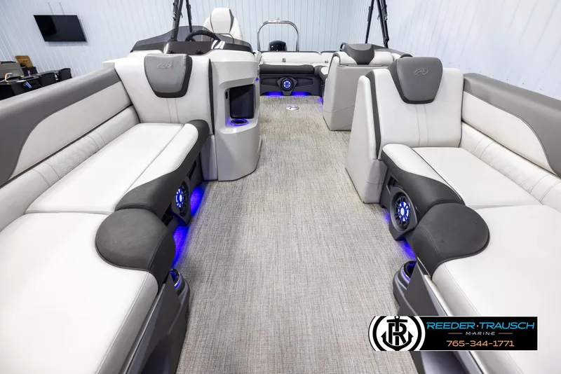 Slide: The Image of 2021 Avalon LSZ VRB boat interior with luxurious seating and ambient blue lighting. - 12