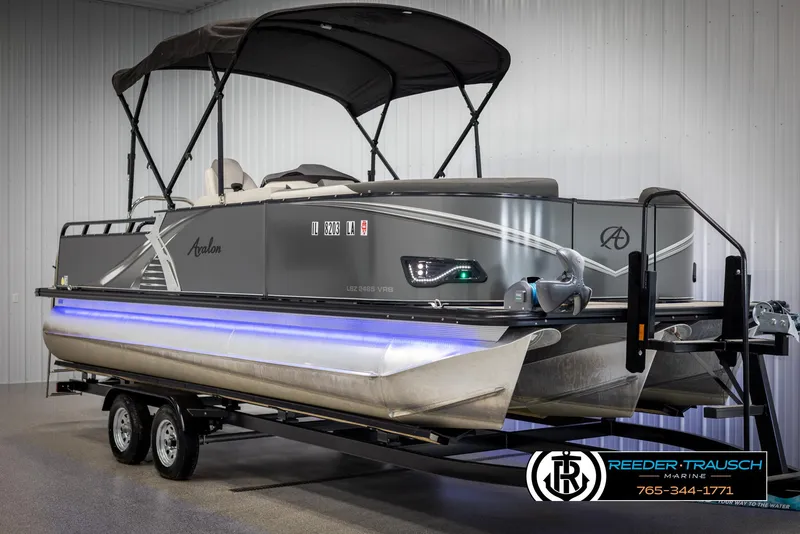 Slide: The Image of 2021 Avalon LSZ VRB pontoon boat on trailer, featuring sleek design and canopy. - 2