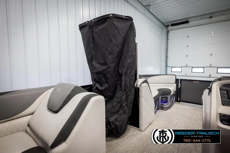 Slide: The Image of 2021 Avalon LSZ VRB boat interior with plush seating in a garage setting. - 20