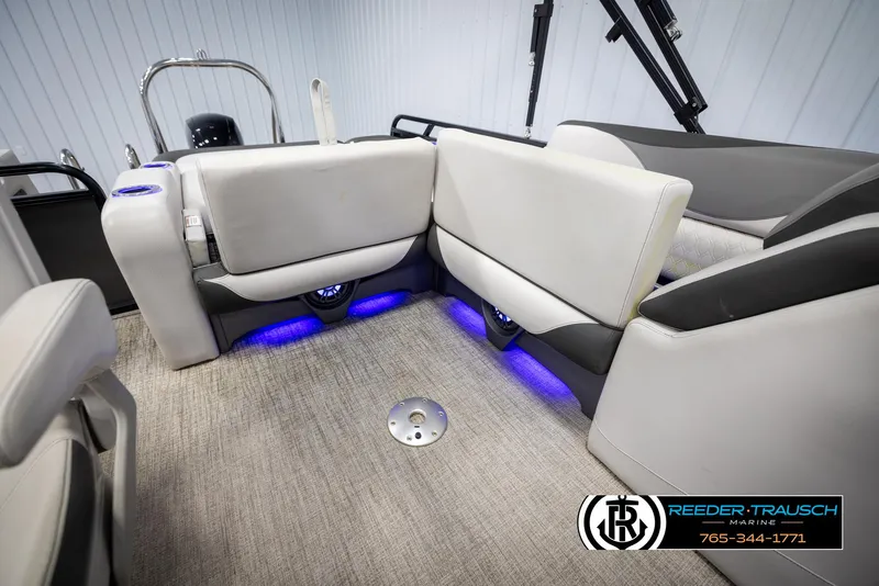 Slide: The Image of 2021 Avalon LSZ VRB boat interior with plush seating and ambient blue lighting. - 25