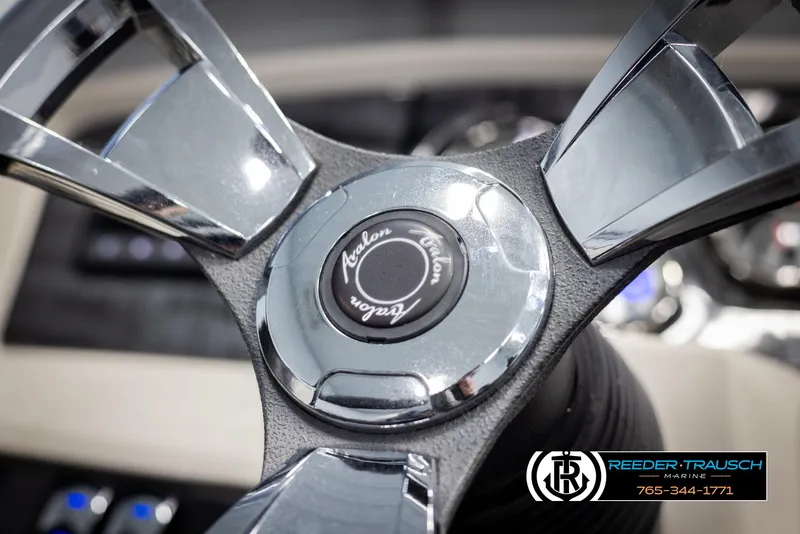 Slide: The Image of Steering wheel of 2021 Avalon LSZ VRB boat, featuring chrome accents and logo. - 28