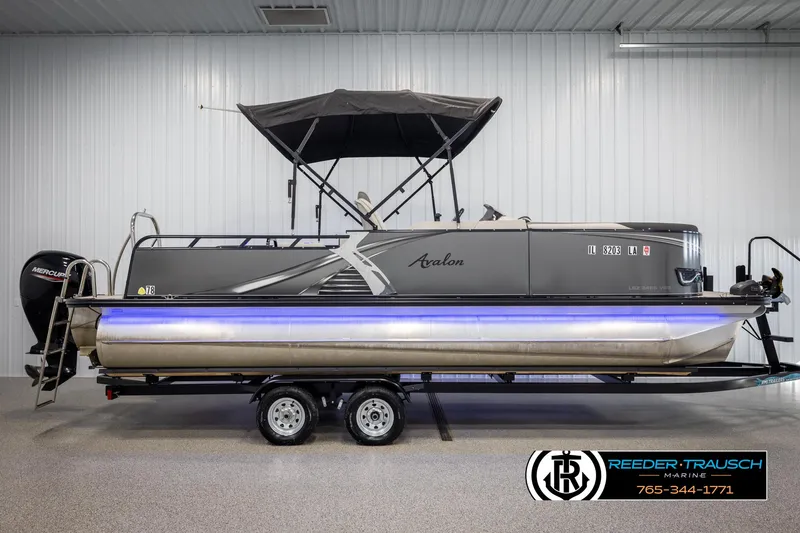 Slide: The Image of 2021 Avalon LSZ VRB pontoon boat with canopy on trailer in showroom. - 4