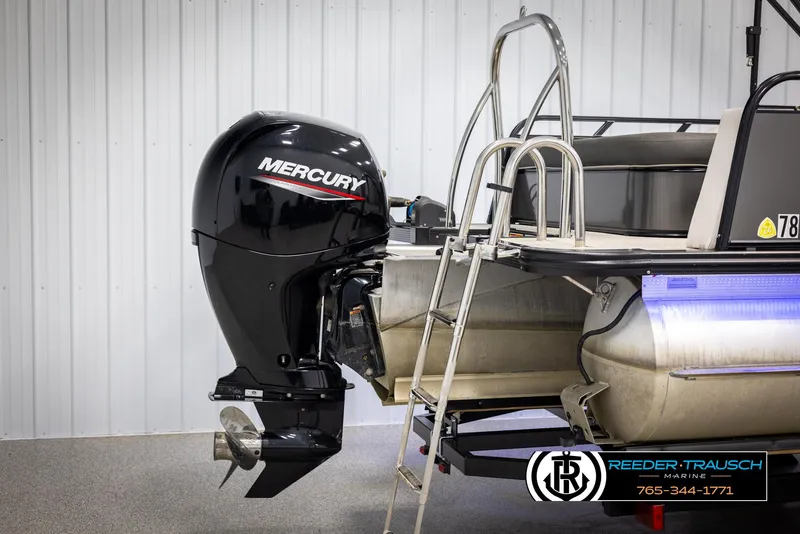 Slide: The Image of 2021 Avalon LSZ VRB boat with Mercury outboard motor and ladder, displayed indoors. - 43
