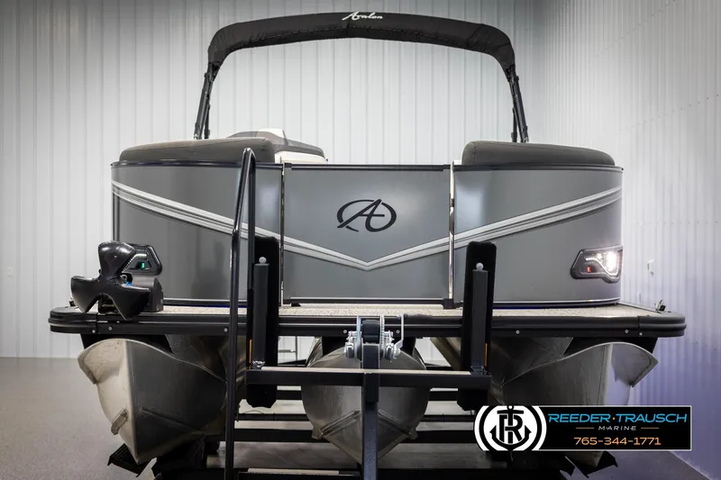 Slide: The Image of 2021 Avalon LSZ VRB pontoon boat in showroom, front view with logo and contact details. - 7