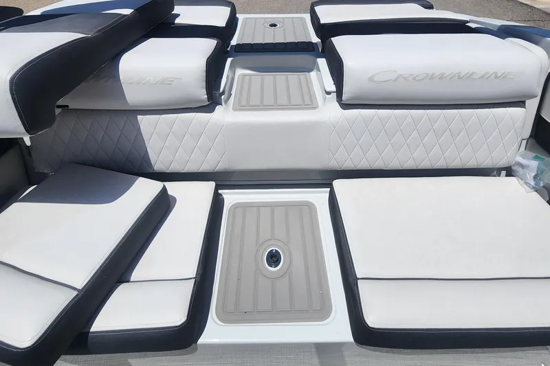 Slide: The Image of 2024 Crownline 200SS boat interior with cushioned seating and sleek design. - 12