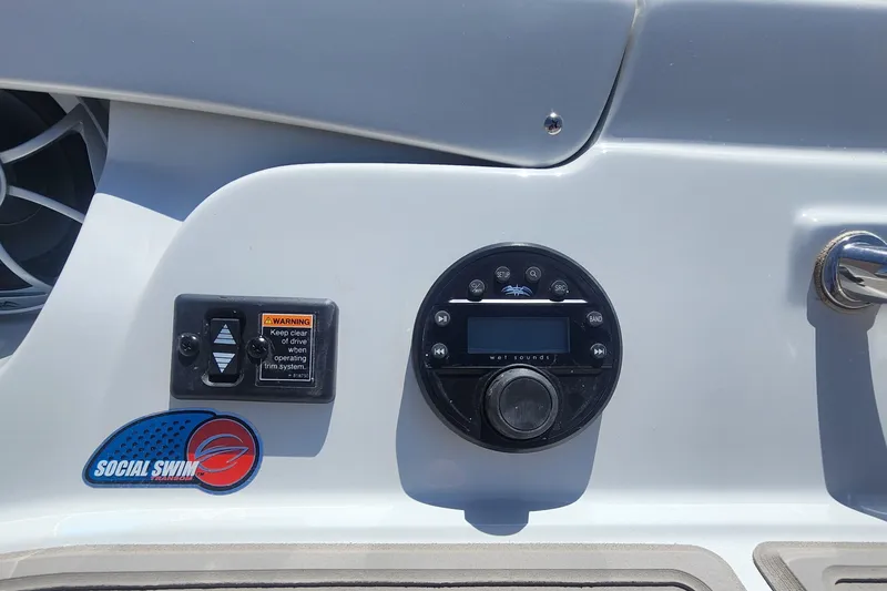 Slide: The Image of 2024 Crownline 200SS boat dashboard with control panel and "Social Swim" logo. - 15