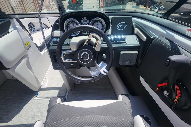 Slide: The Image of 2024 Crownline 200SS boat interior with modern dashboard and steering wheel. - 5