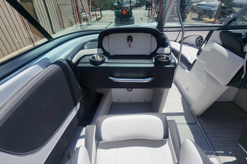 Slide: The Image of 2024 Crownline 200SS boat interior with modern seating and sleek dashboard design. - 6