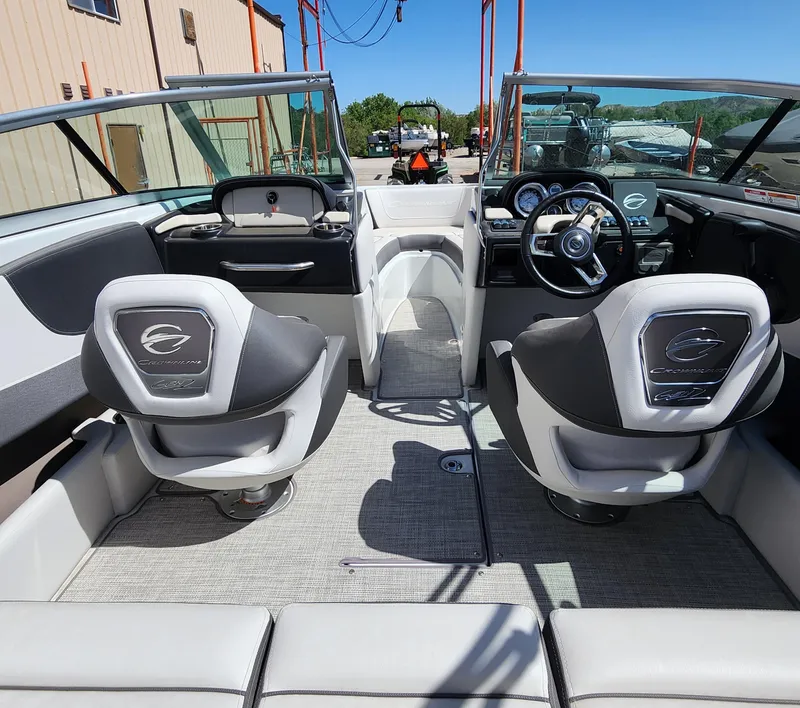 Slide: The Image of 2024 Crownline 200SS boat interior with dual seats and steering wheel, showcasing modern design. - 8