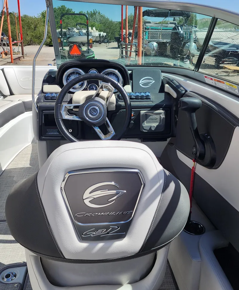 Slide: The Image of 2024 Crownline 200SS boat interior with steering wheel and dashboard controls. - 9