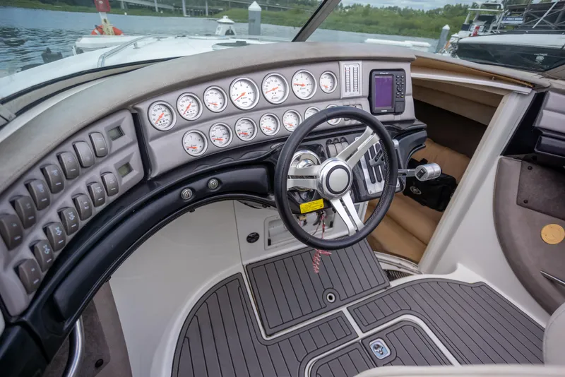 Slide: The Image of Cockpit of 2005 Cobalt 343 boat with gauges, steering wheel, and control panel. - 17
