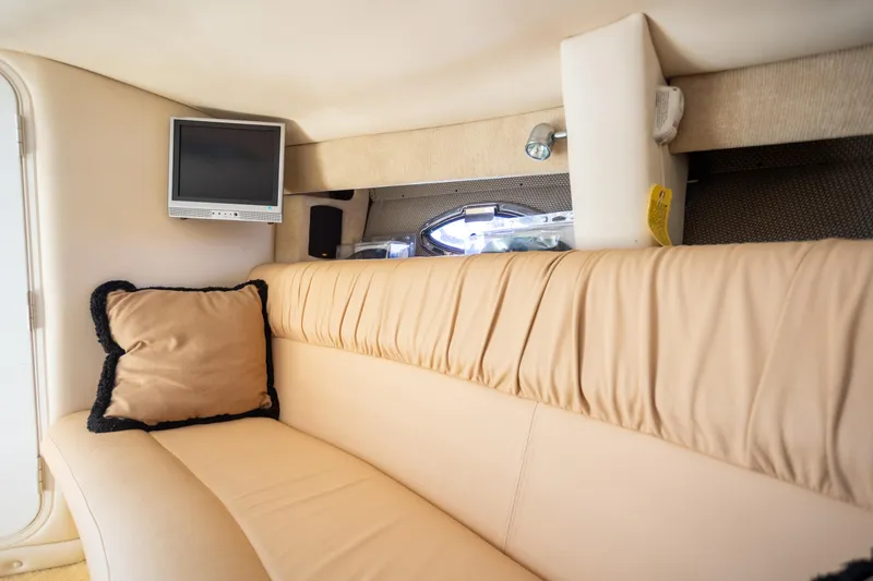 Slide: The Image of Interior of 2005 Cobalt 343 boat with beige seating and small TV. - 21
